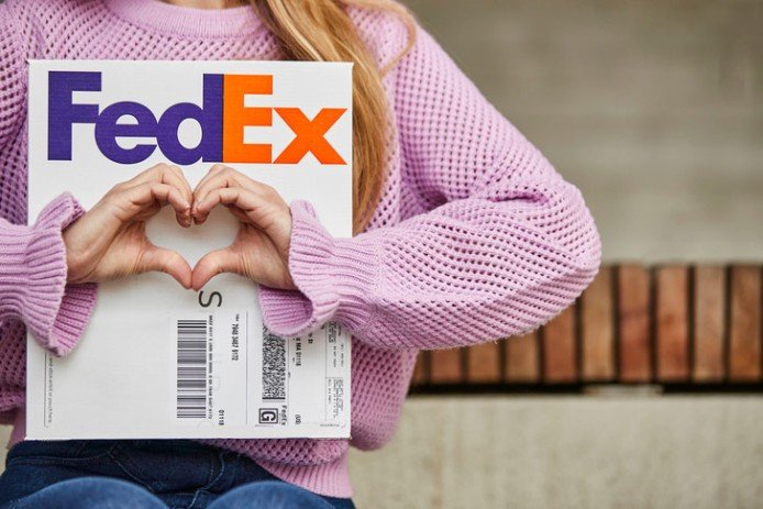 FedEx courier with Clipboard in a warehouse